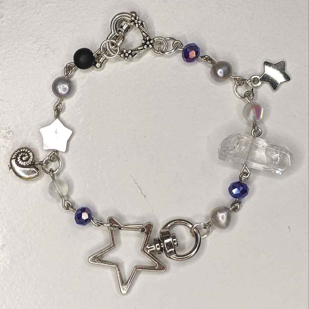 Bracelet with silver and blue beads charms and star beads. Handmade by me.